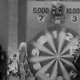 A You Bet Your Life contestant watches the spinning wheel while host Groucho Marx does not.
